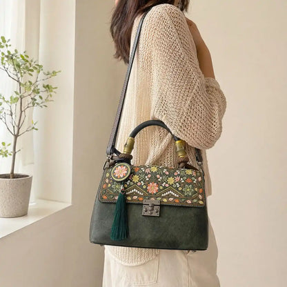 Faceless Asian woman wears beige hollow knit cardigan, crossbody dark green vintage floral handbag with bamboo handle and green tassel, warm minimalist indoor window background