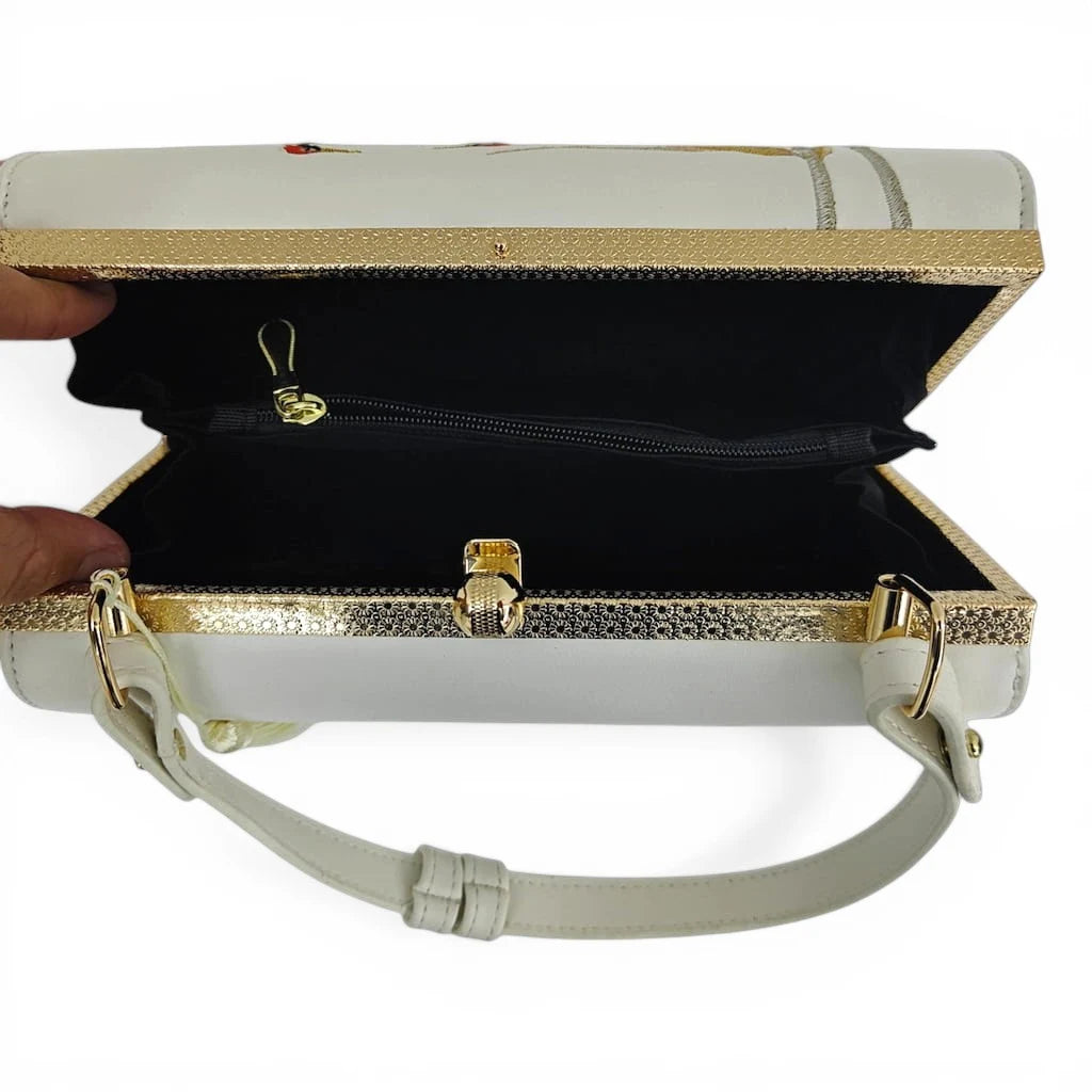 interior view of white crane embroidered clutch bag with black fabric lining and inner zipper pocket